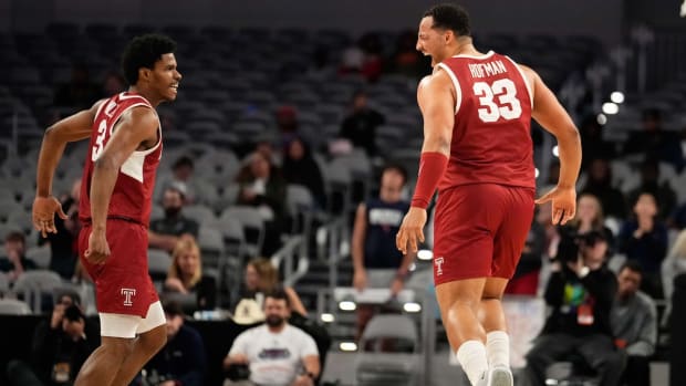Temple Owls forward Sam Hofman (33) celebrates with Temple Owls guard Hysier Miller (3) after scoring a three point basket against the Florida Atlantic Owls during the second half at Dickies Arena in Fort Worth, on March 16, 2024.